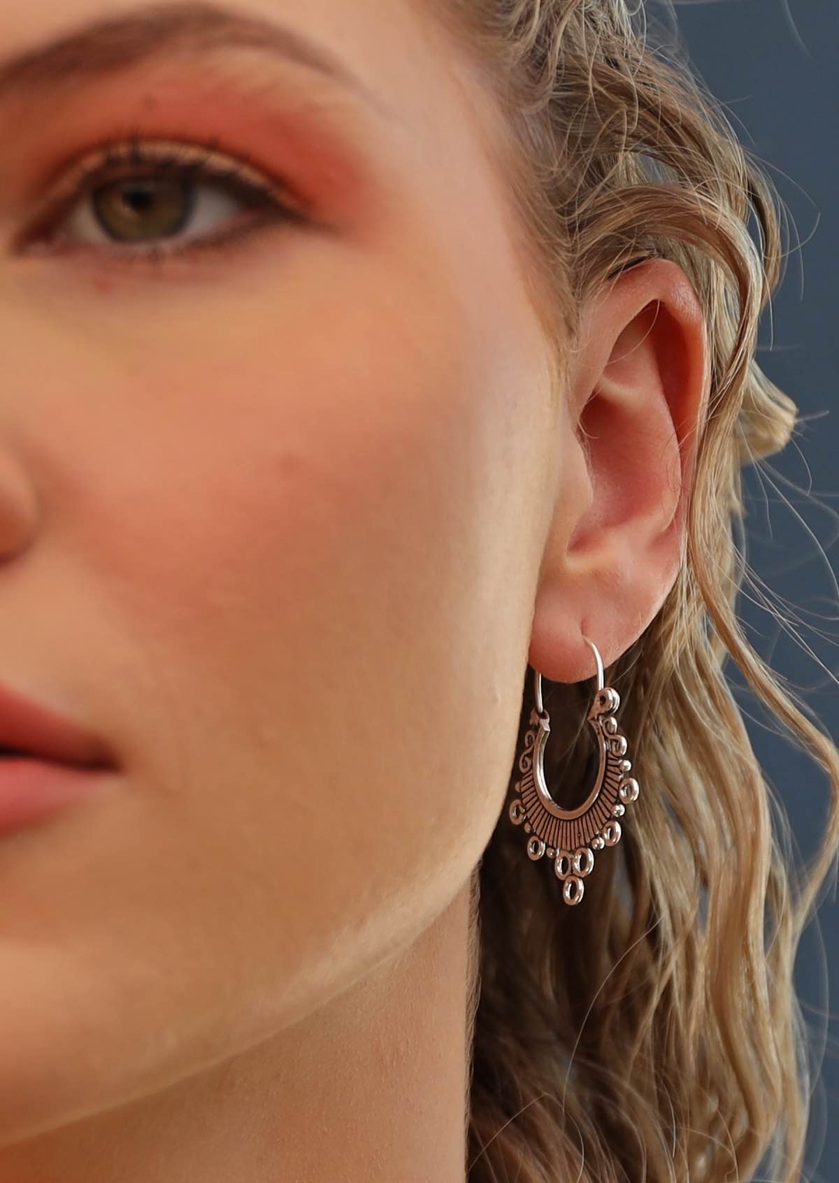 woman wearing silver hill tribe earrings