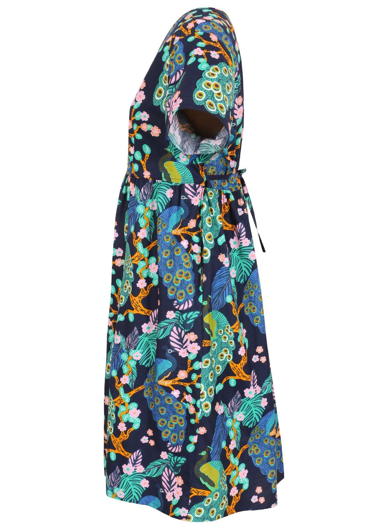 Side view of a navy blue based floral cotton button through dress with short sleeves