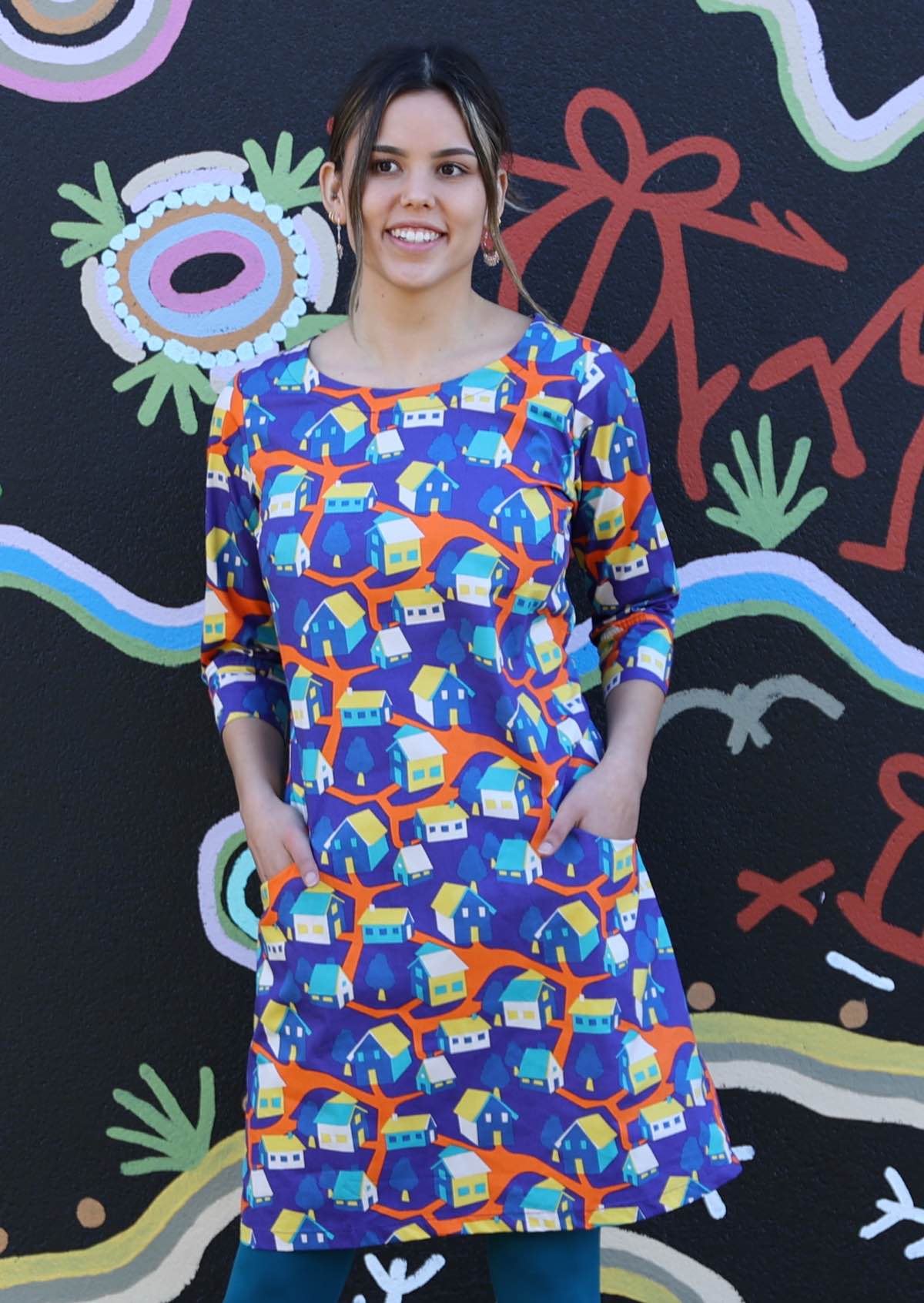 Model in Jamie Dress round neck 3/4 sleeve pockets 100% cotton colourful house print