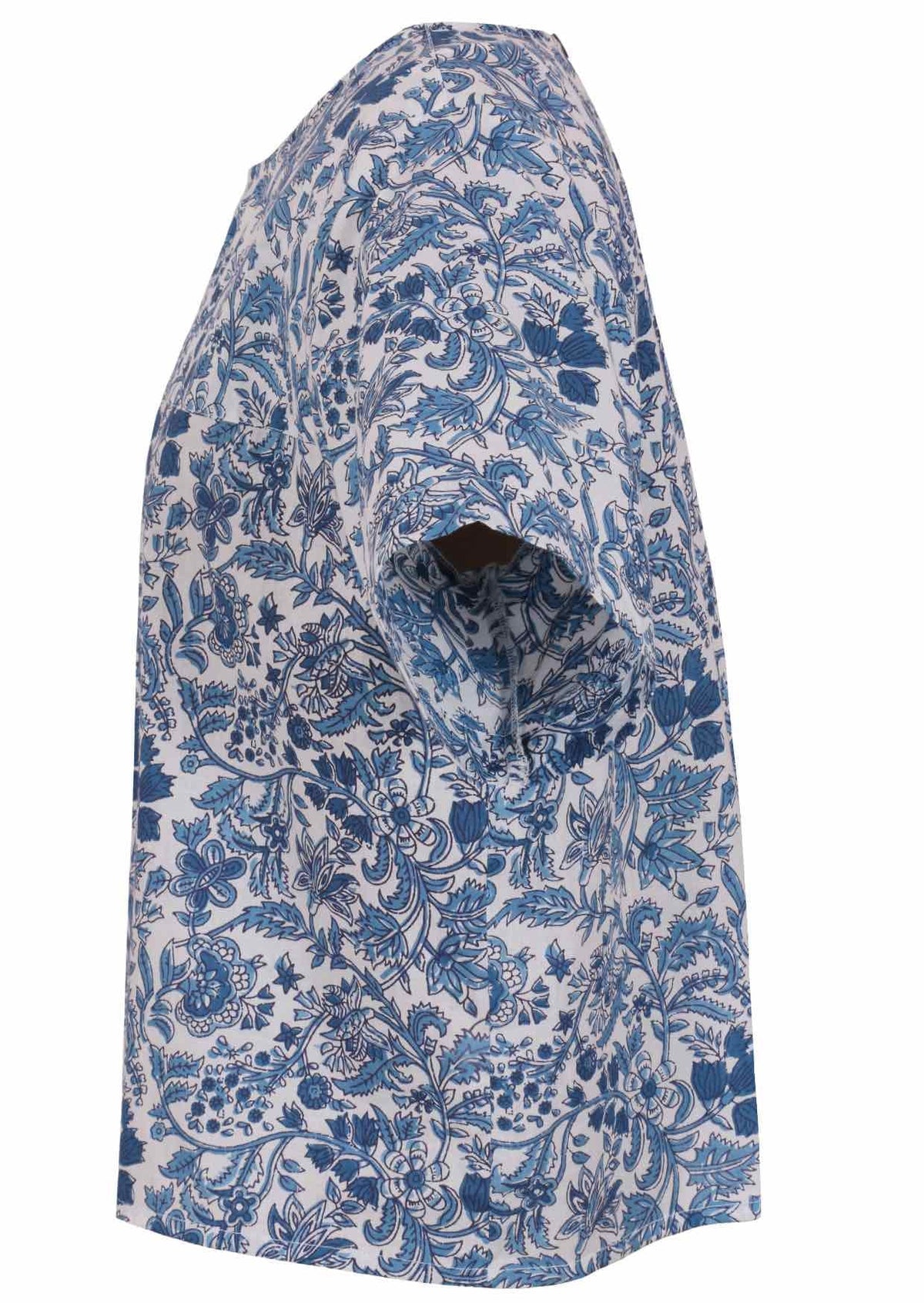 Side view of white based blue floral print cotton relaxed fit short sleeved top with round neckline