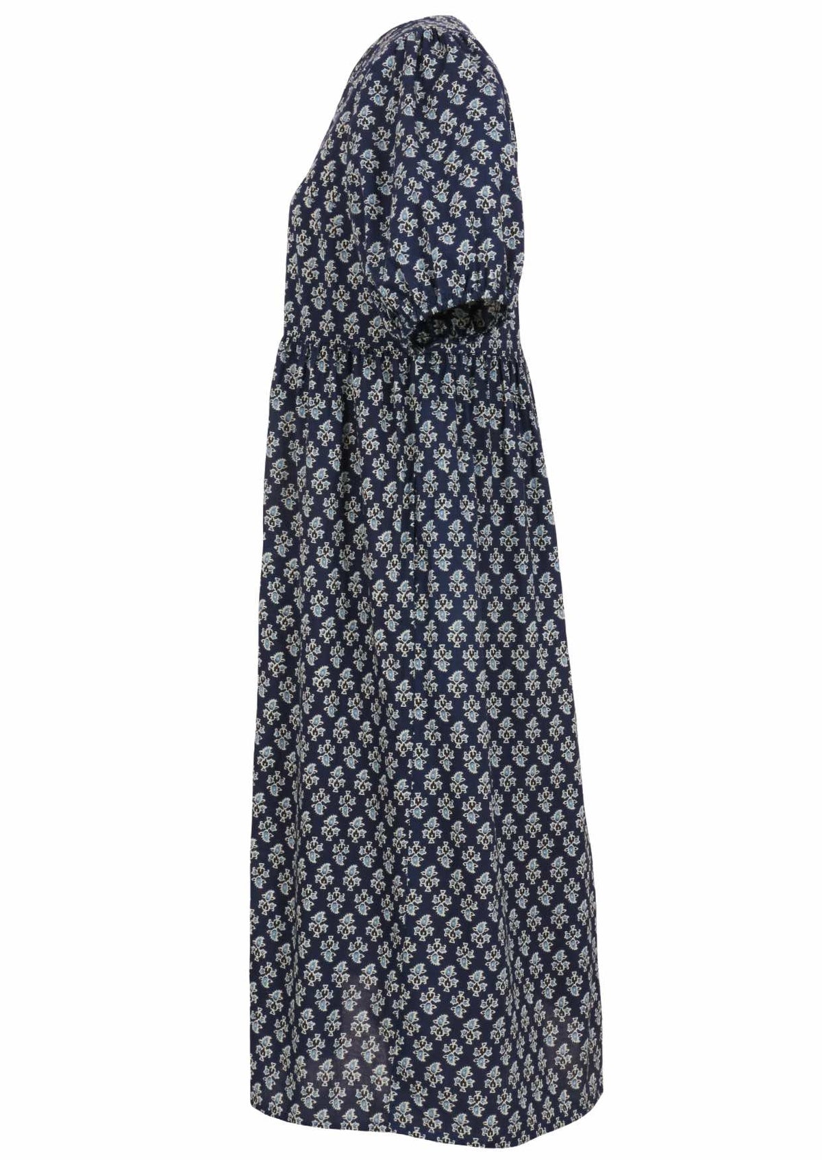 Side view of navy blue floral motif printed cotton midi length button through dress with hidden side pockets.