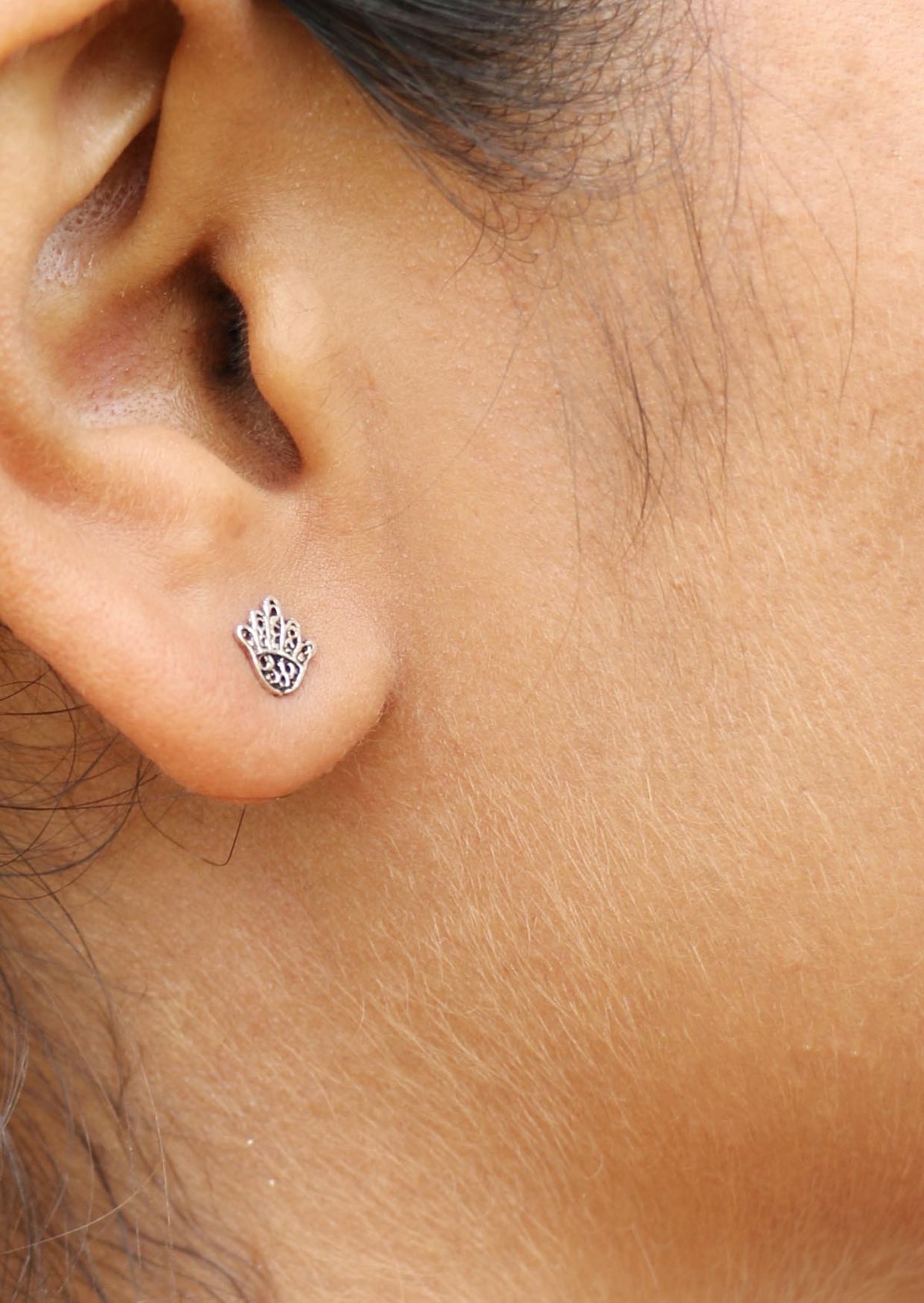 Delicate sterling silver Hand of Fatima studs with intricate lacework and secure butterfly backs