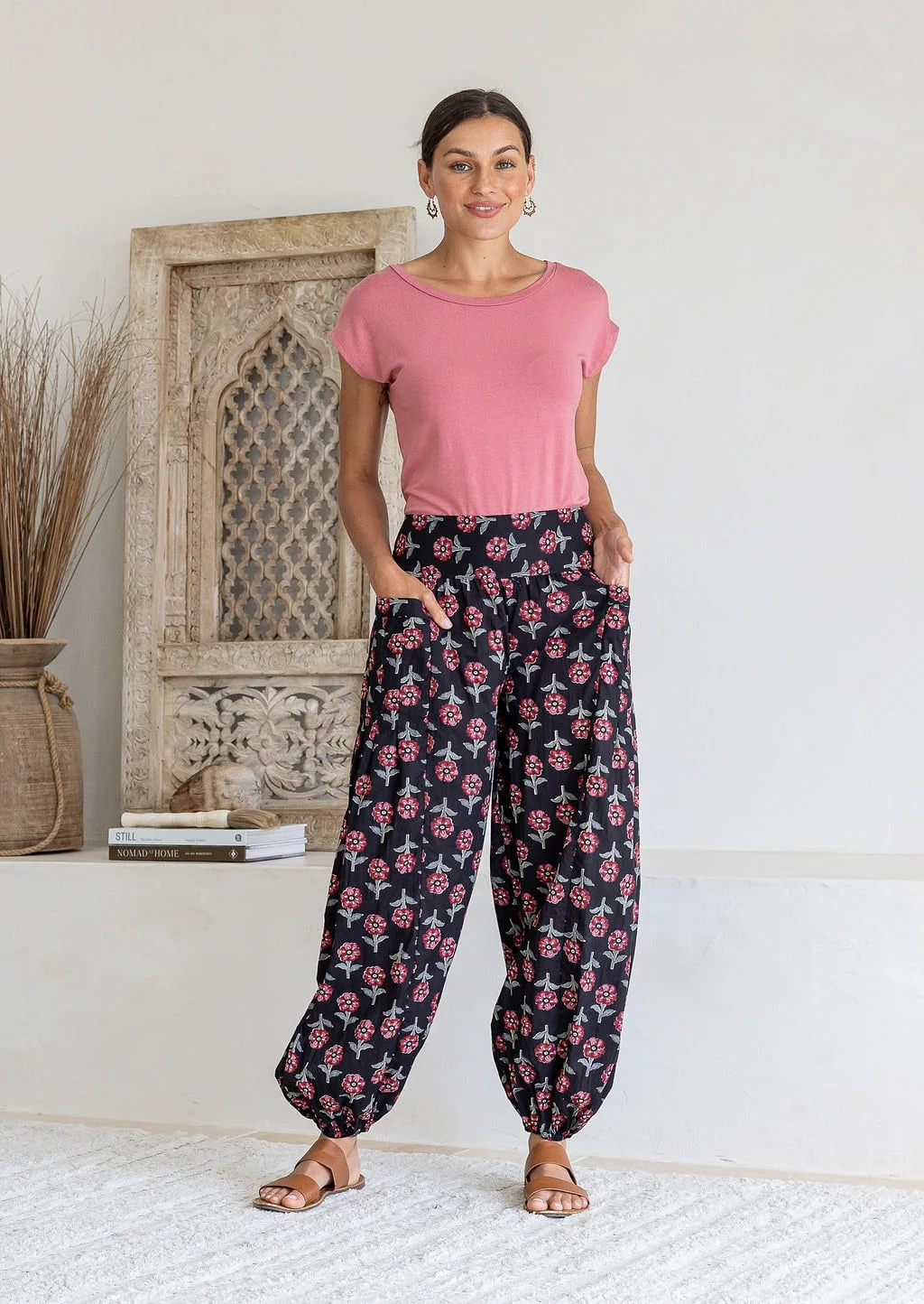 Model wears cotton harem pants with elasticated ankles, wide waistband and deep pockets.