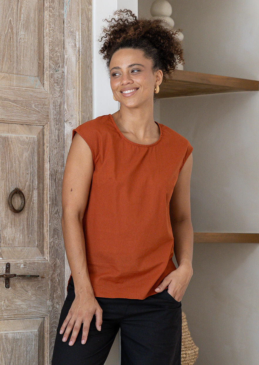 Woman wearing 100% cotton top in orange brushetta colour with round neckline