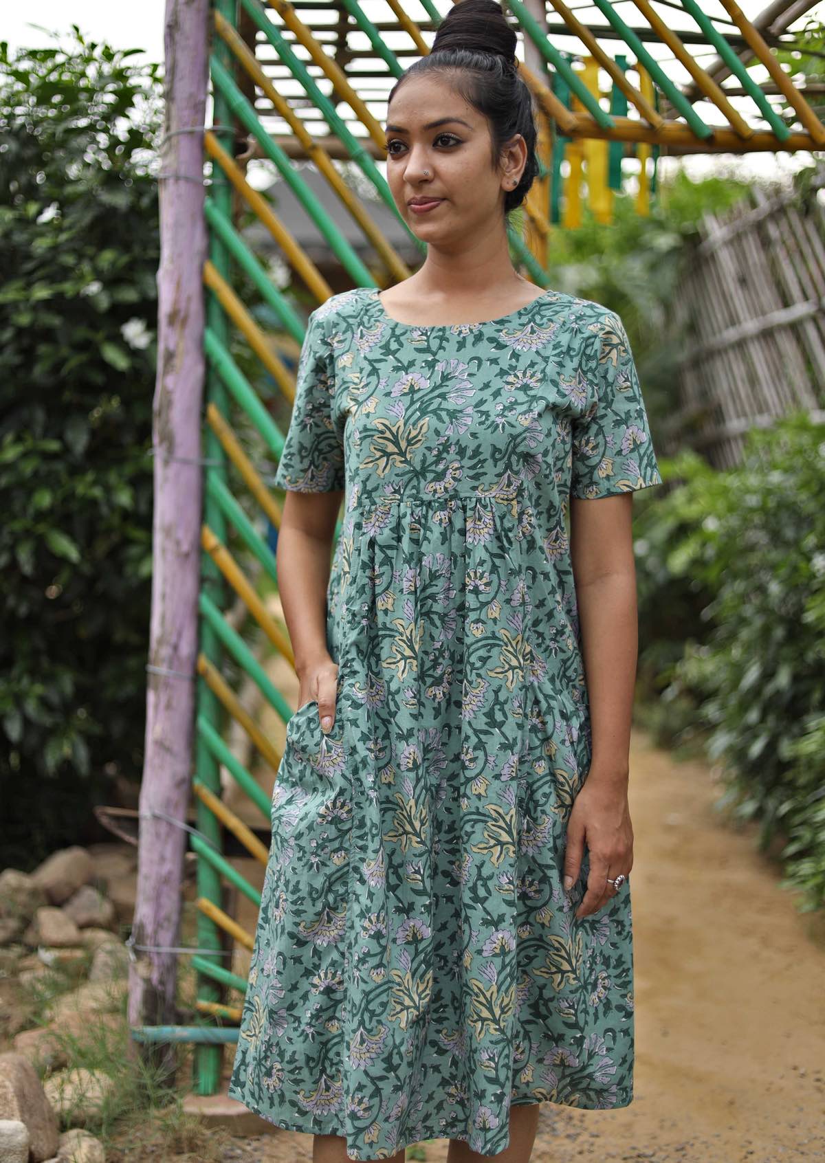 Model wearing Frankie Dress Short Sleeve 100% Cotton Dress round neck, gathered pleats under bust, knee length skirt and pockets