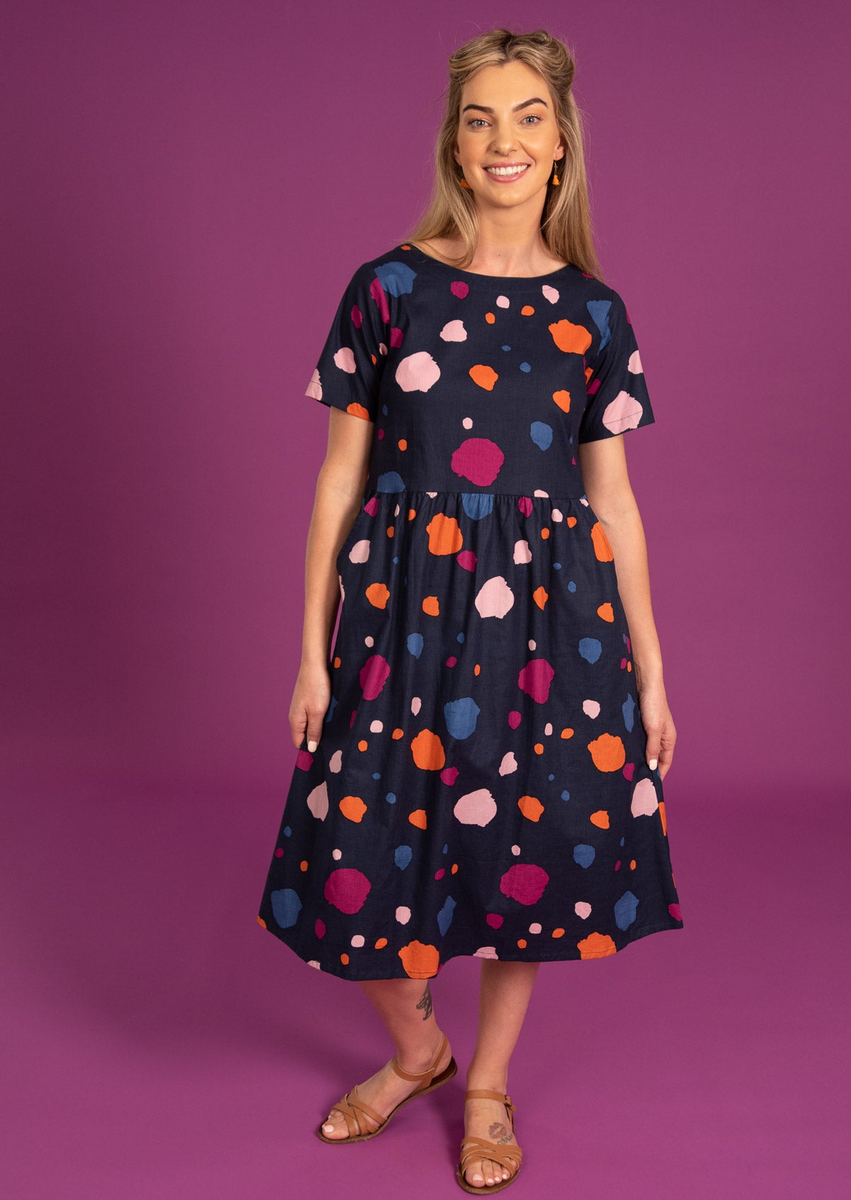 Short sleeve cotton dress with pockets and small pintucks at waist.