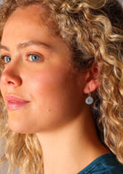 Sweet compass etched into the surface of the sterling silver disc earrings