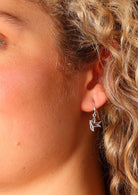 Sterling silver mini swift birds suspended from wire hooks