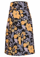 Side view of black based floral print cotton A-line skirt with pockets and side zip