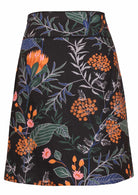Back image of a above knee length black cotton skirt with piped detailing, pockets and a side zipper