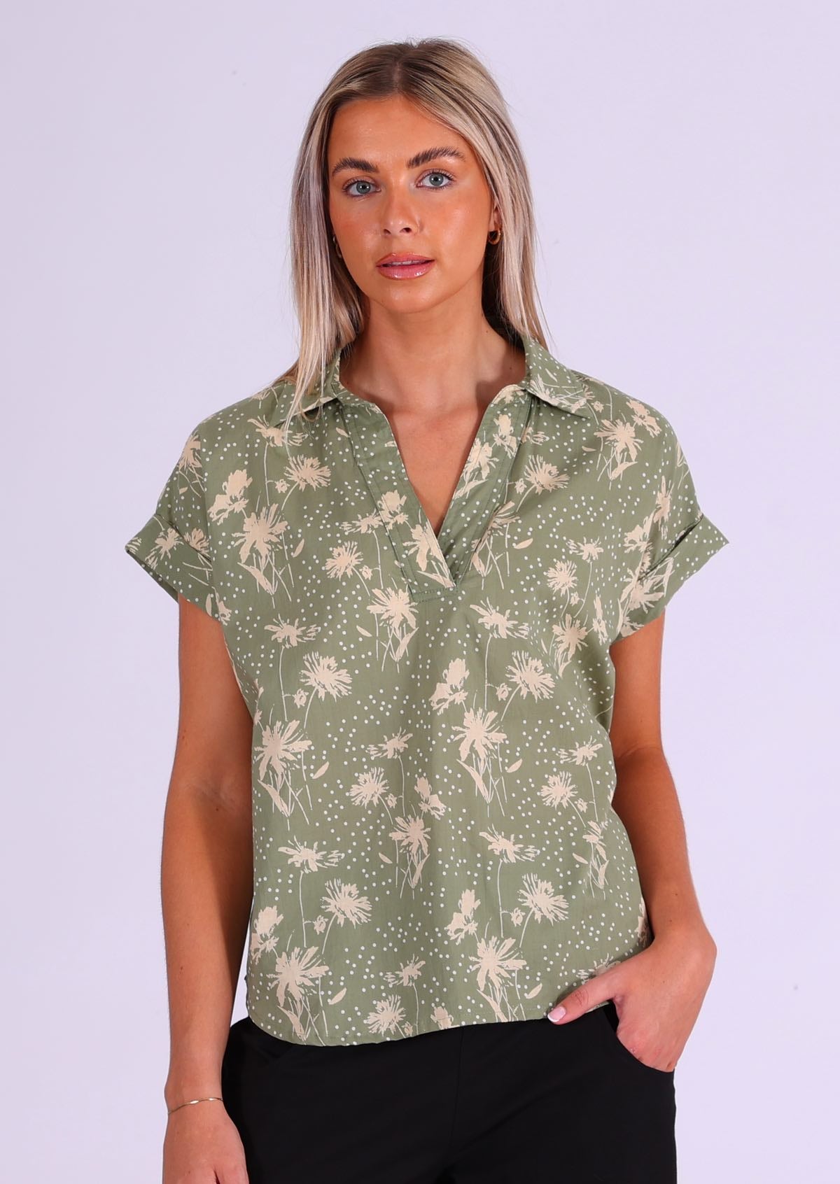 Model wears pale green base floral pattern cotton relaxed fit top with folded cuffs and a collar