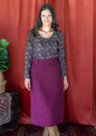 woman wearing purple corduroy skirt with cotton top