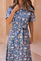 100% cotton shirt style button through dress in gorgeous pink, yellow and green florals on blue background.
