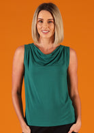 Woman wearing green cowl neck singlet top