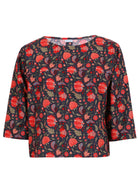 3/4 sleeve cotton boxy top with a high round neckline in floral print on a blue base