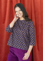 Model pairing a beautiful floral printed cotton top in dark purple with esta corduroy pants in plum shade.