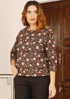 Woman wears 100% cotton, loose fit top with 3/4 sleeves and wide round neckline 