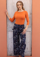 100% cotton cord pants with printed white florals on navy blue base.
