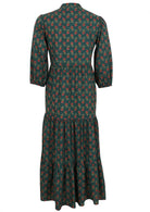 Back view of a full length maxi dress with 3 tiered flowy skirt, mandarin collar, buttoned bodice and pockets