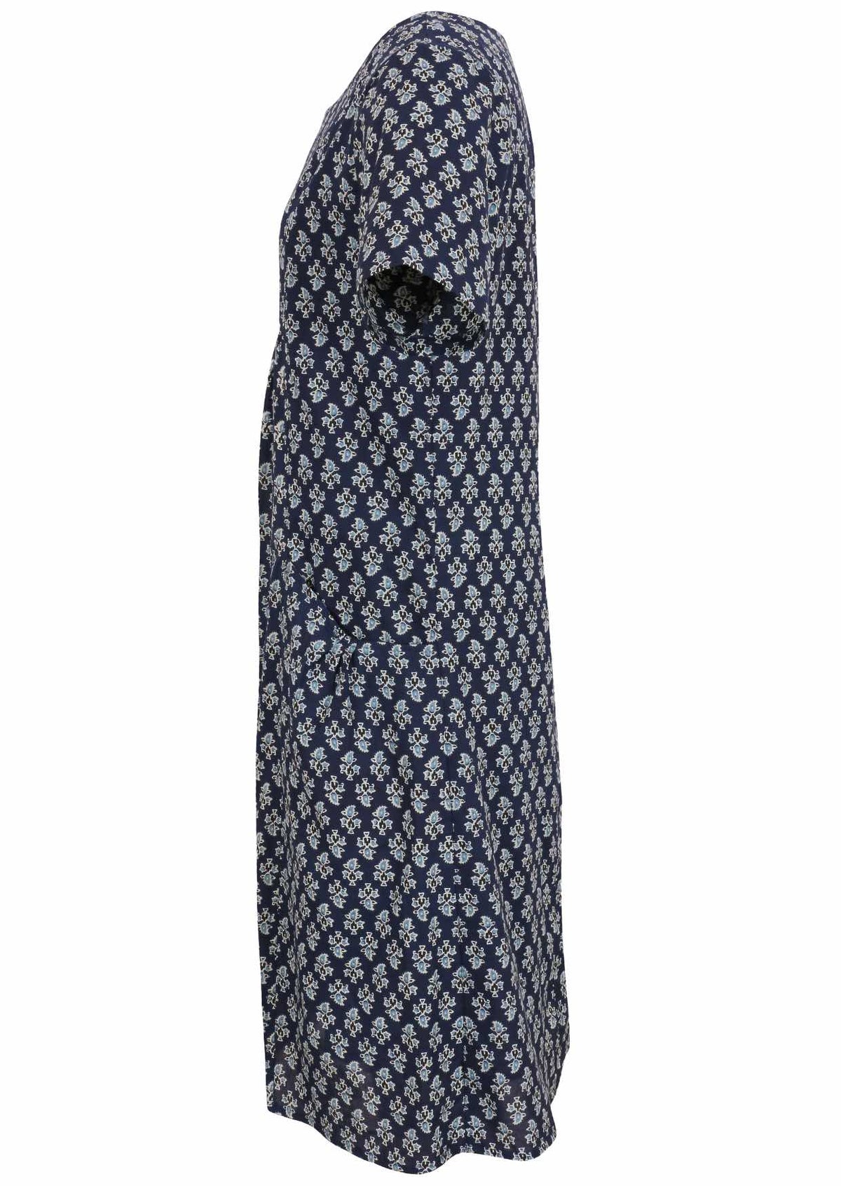 Side view of cotton dress with round neckline and short sleeves in navy blue based floral print. 