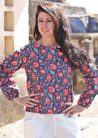 Model poses in cotton long sleeve top with boat neckline and bishop sleeves, in floral print