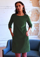 Woman wearing green corduroy A-line dress 