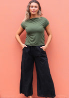 Woman wearing black cotton wide leg pants and green t-shirt 
