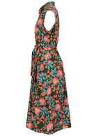 Side view of olive green based floral print cotton dress with pockets.