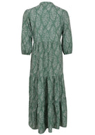 Back view of a full length maxi dress with 3 tiered flowy skirt, mandarin collar, buttoned bodice and pockets