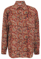 Cotton long sleeve collared shirt with coconut buttons and one breast pocket in Indian floral print on a rust base