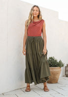 Model wearing a 100% cotton skirt in plain olive green shade paired with a pink top