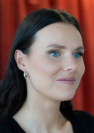 woman wearing medium sized silver hoop earrings 92.5 Sterling Silver
