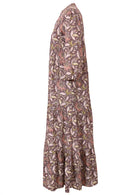 Side view of a full length maxi dress with 3 tiered flowy skirt, mandarin collar, buttoned bodice and pockets