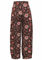 Back view of 100% cotton wide leg cotton pant with black based floral print with pockets.