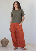 Pilot Pants high-mid waist waistband elasticated back flat front loose fitted leg elasticated at ankles front pockets 100% cotton light weight rust shade