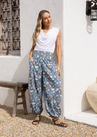 Models stands in sun wearing a 100% cotton harem style pants with elasticated waist and ankles