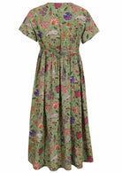 Green based multi-coloured folk style florals print cotton dress on a white background.