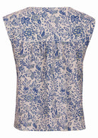 Cap sleeves top with white based blue floral print on a white background.