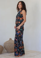 Model standing with hand in pocket wearing a matching cotton top and high waisted pant with side zipper and wide leg fit