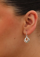 art nouveau style dangly earring on woman's ear