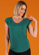 Woman wearing a green v-neck short cap sleeve rayon top