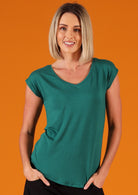 Woman with blonde hair wearing a green v-neck short cap sleeve rayon top