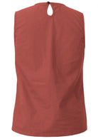 Back view of cotton sleeveless top in rust colour with relaxed fit and button at back of the neck 
