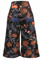 Back view of cotton wide leg printed pants  in 3/4 length with pockets and side zipper
