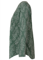 Side image of long sleeve cotton top with sage green based floral print.