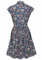 Blue floral shirt style cotton dress with pockets, cap sleeves and small gathers at back waist