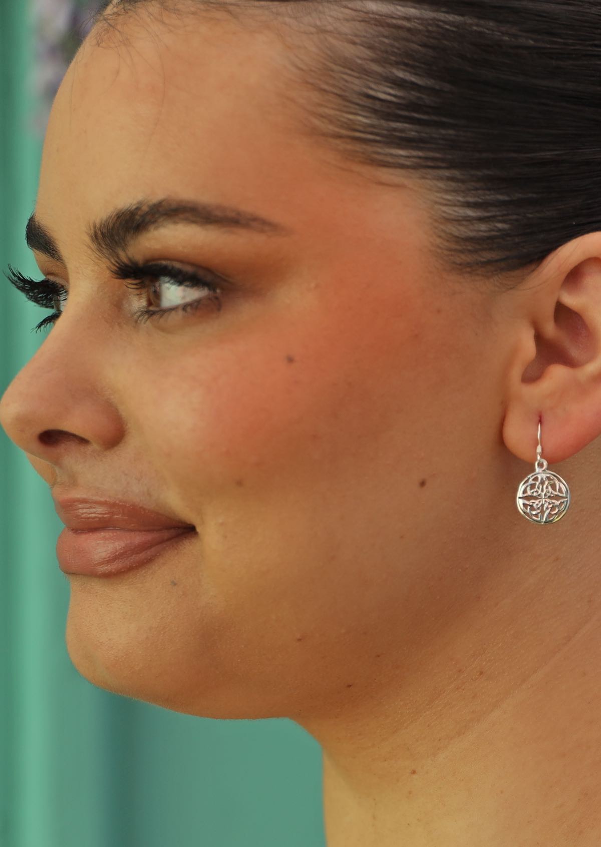 celtic style circle dangle earrings on woman with dark hair
