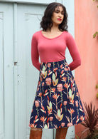 Zarah Skirt, wide waistband below the knee length wide a-line cut side pockets side zipper 100% cotton with navy background native botanic print | Karma East Australia