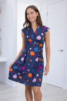 Model poses in V-neck Knee Length retro inspired Dress with cap sleeves and structured bodice