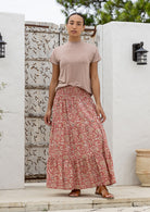 woman wearing a simple pink top and 100% cotton maxi skirt in rose pink based floral print. 
